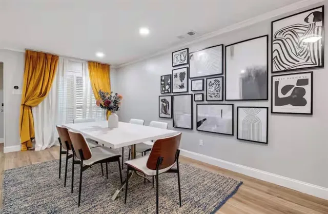 a view of a dining room with furniture and window