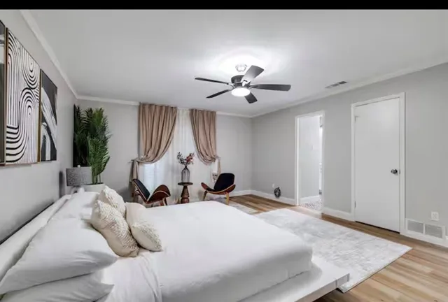 a bed room with a bed and a chandelier