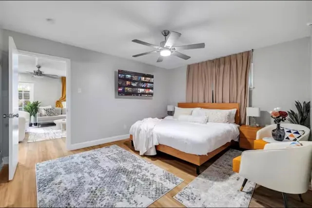 a bedroom with a bed and a chandelier