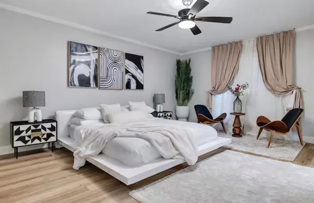 a bedroom with a bed and a chandelier