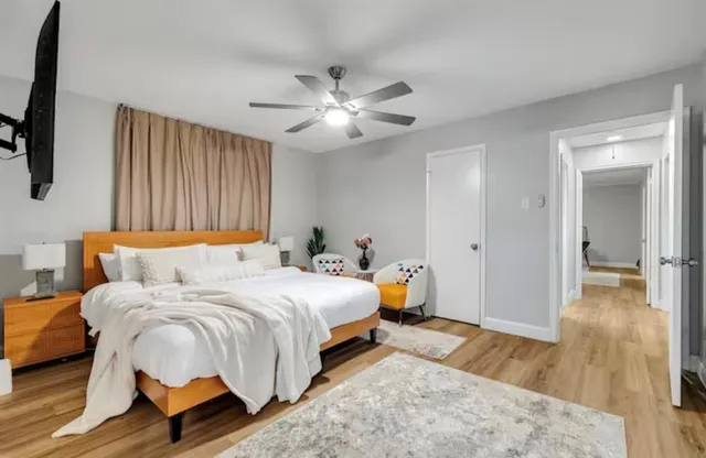 a bedroom with bed and a chandelier