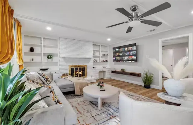 a living room with furniture fireplace and window