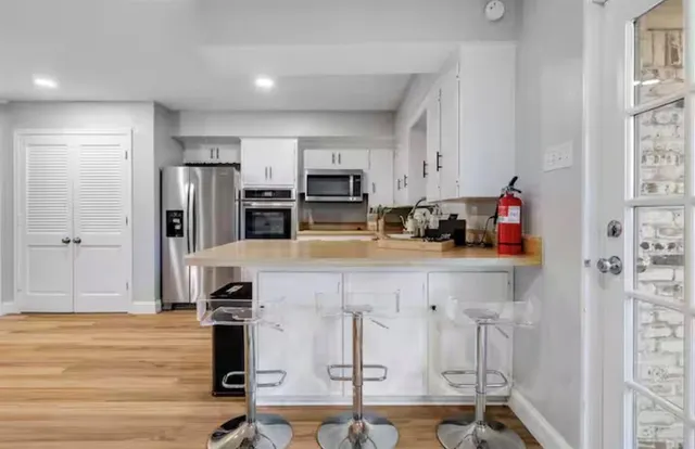 a kitchen with a refrigerator stove and sink
