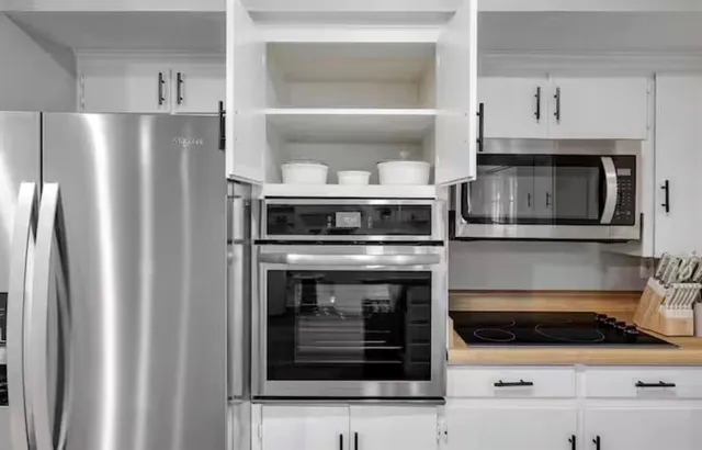 a kitchen with stainless steel appliances refrigerator microwave and stove