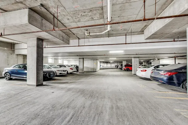 a view of parking garage with cars