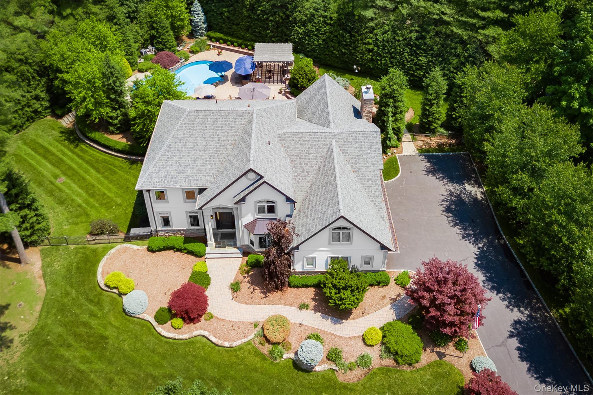 an aerial view of a house with yard swimming pool and outdoor seating