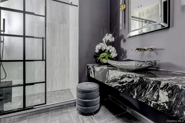 a bathroom with a granite countertop sink and a mirror
