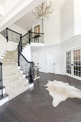 a view of staircase with lots of frames and a rug