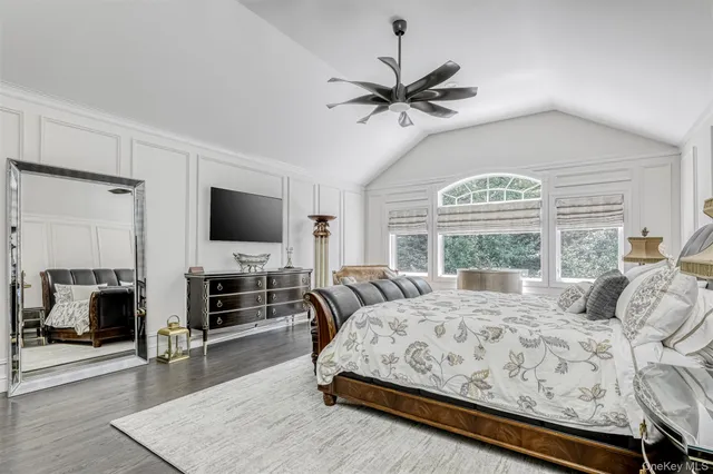 a bedroom with a large bed and a flat screen tv