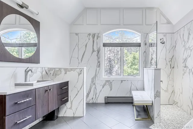 a spacious bathroom with a toilet a sink and a window