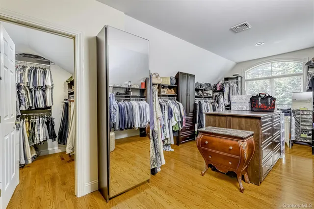 a bedroom with furniture and a gym machine