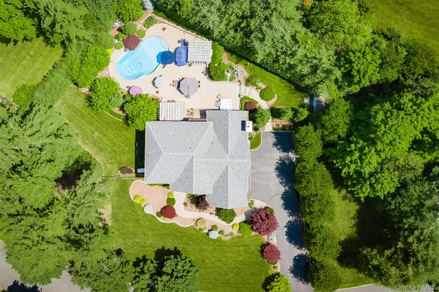 an aerial view of residential house with yard and swimming pool