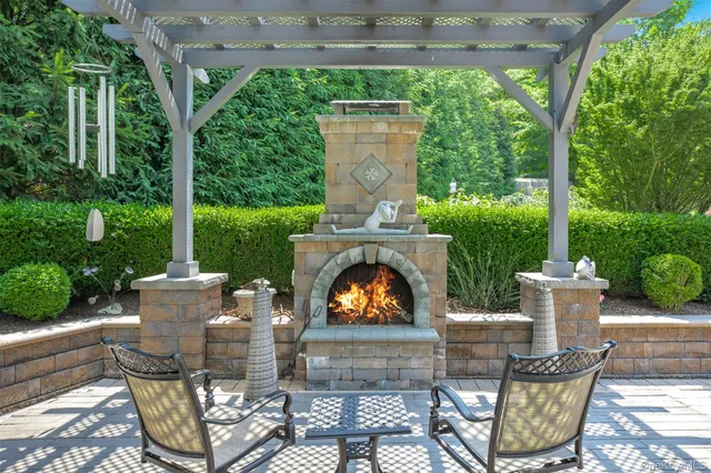 a view of a patio with table and chairs potted plants with large tree