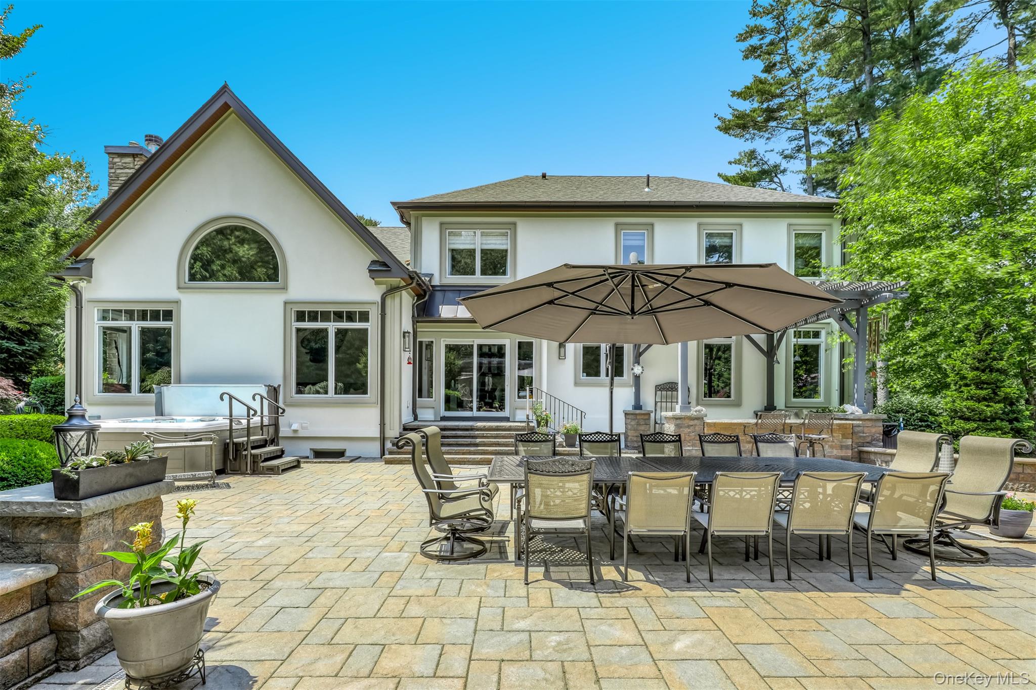 6 Par Road Suffern, NY 10901 - Photo 36 of 41 a view of a white house with table and chairs under an umbrella