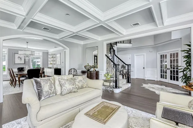 a living room with furniture and wooden floors