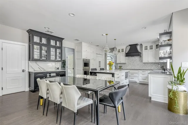 a kitchen with a table chairs stove and cabinets