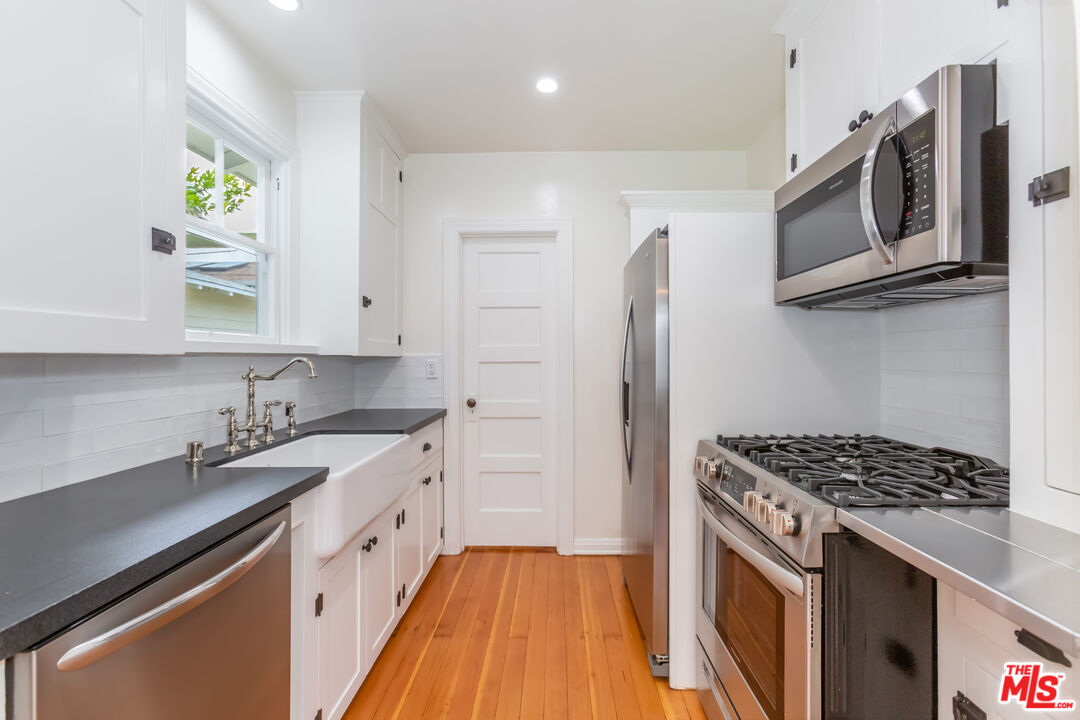 9980 Braddock Drive Culver City, CA 90232 - Photo 15 of 29 a kitchen with stainless steel appliances a sink stove and refrigerator