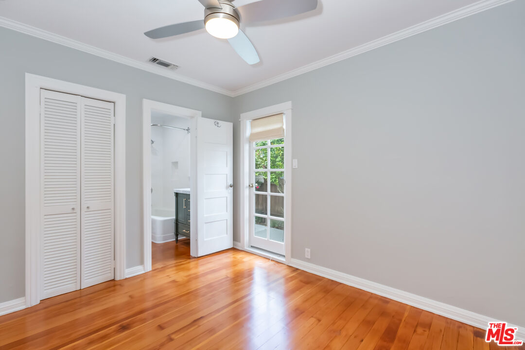 9980 Braddock Drive Culver City, CA 90232 - Photo 22 of 29 an empty room with wooden floor fan and windows