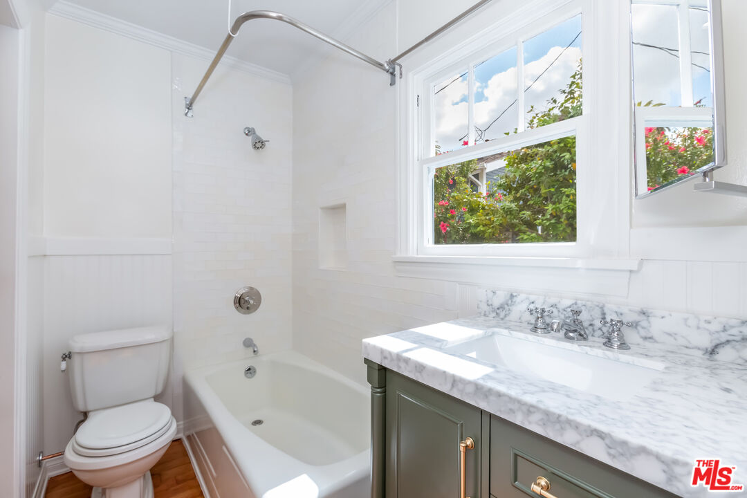 9980 Braddock Drive Culver City, CA 90232 - Photo 23 of 29 a bathroom with a granite countertop sink a toilet and a bathtub