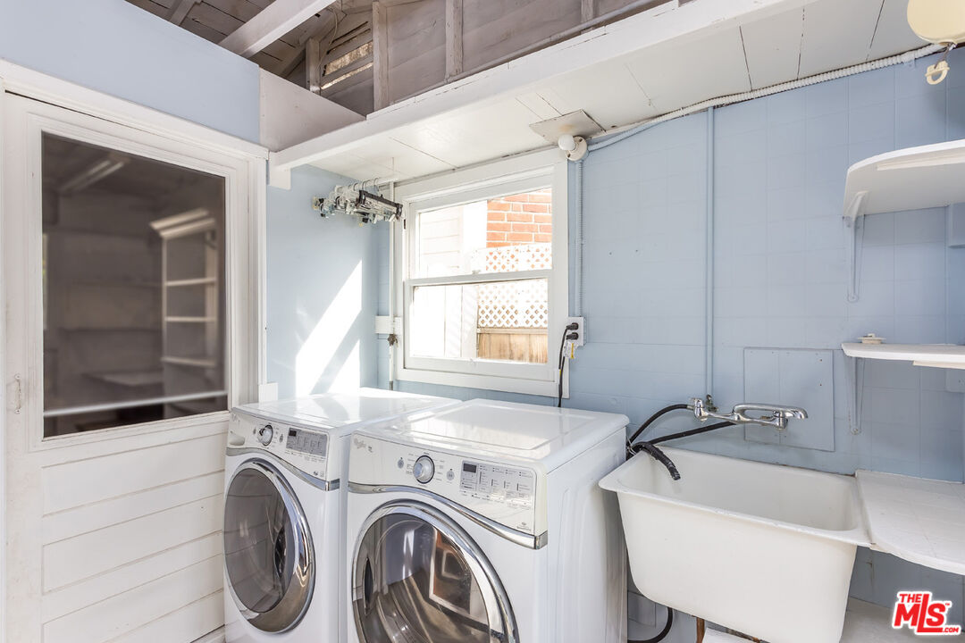 9980 Braddock Drive Culver City, CA 90232 - Photo 29 of 29 a bathroom with a sink a washer and dryer next to a window