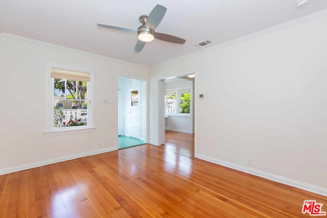 9980 Braddock Drive Culver City, CA 90232 - Photo 7 of 29 an empty room with wooden floor ceiling fan and windows