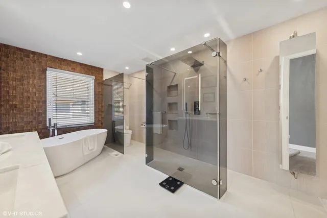 a spacious bathroom with a bathtub shower and toilet
