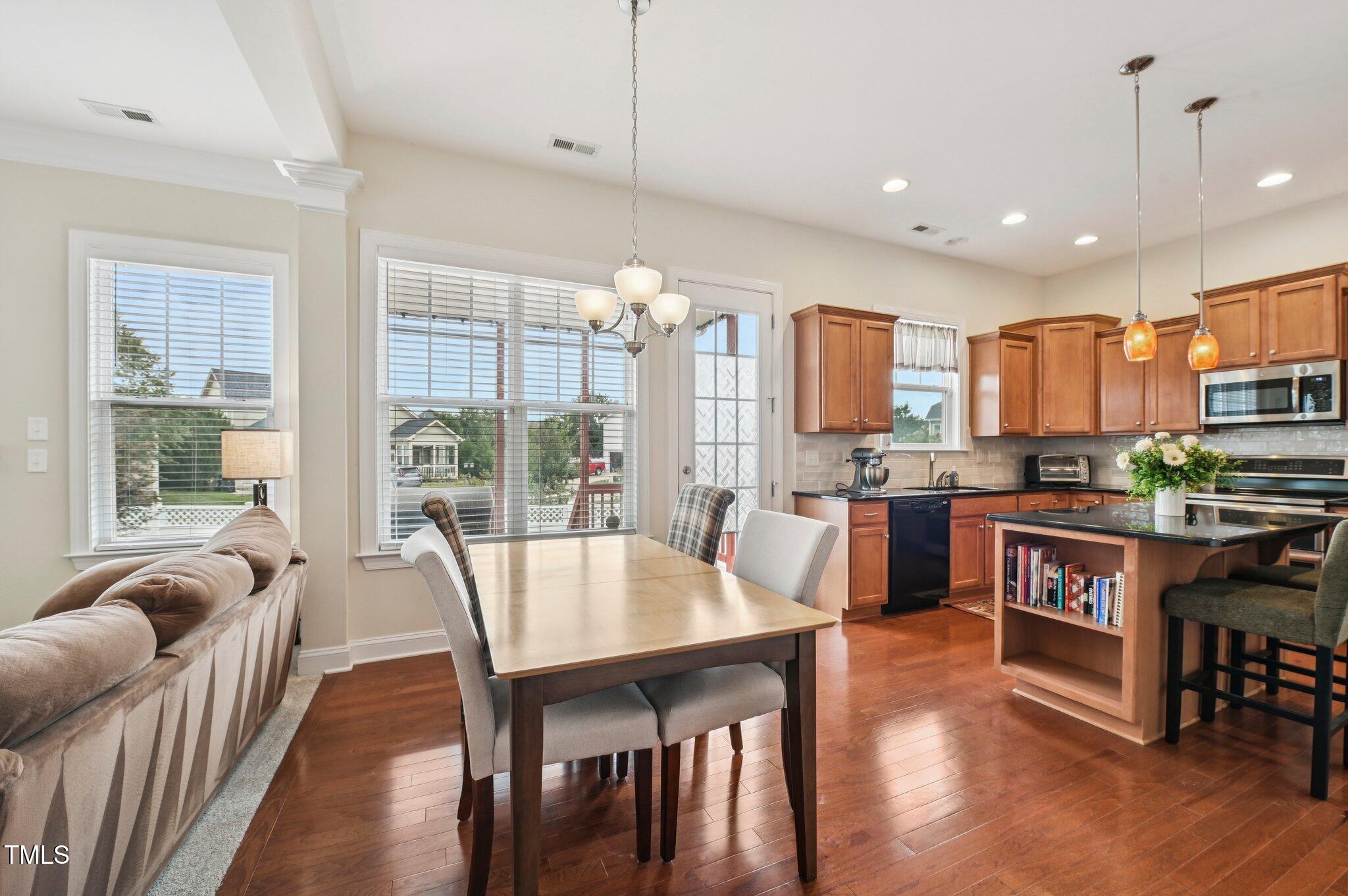 1229 Chapanoke Road Raleigh, NC 27603 - Photo 8 of 42 a view of a dining room with furniture window and wooden floor