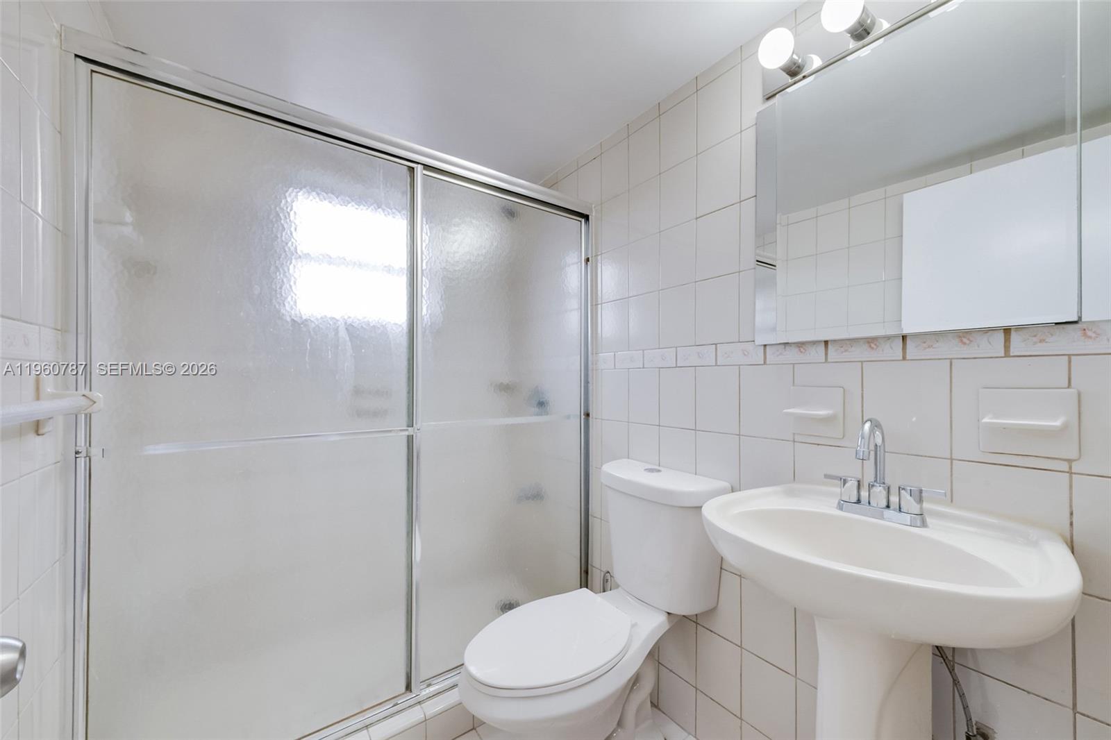 1661 Southwest 3rd Street, Unit 25 Miami, FL 33135 - Photo 12 of 24 a bathroom with a sink toilet and shower