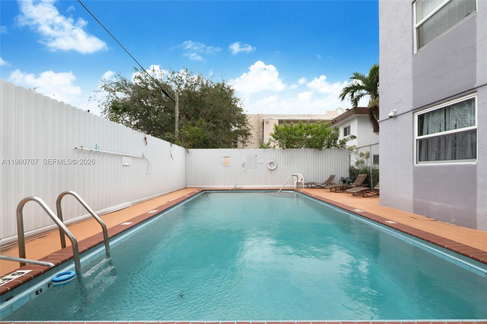 1661 Southwest 3rd Street, Unit 25 Miami, FL 33135 - Photo 15 of 24 a backyard of a house with table and chairs