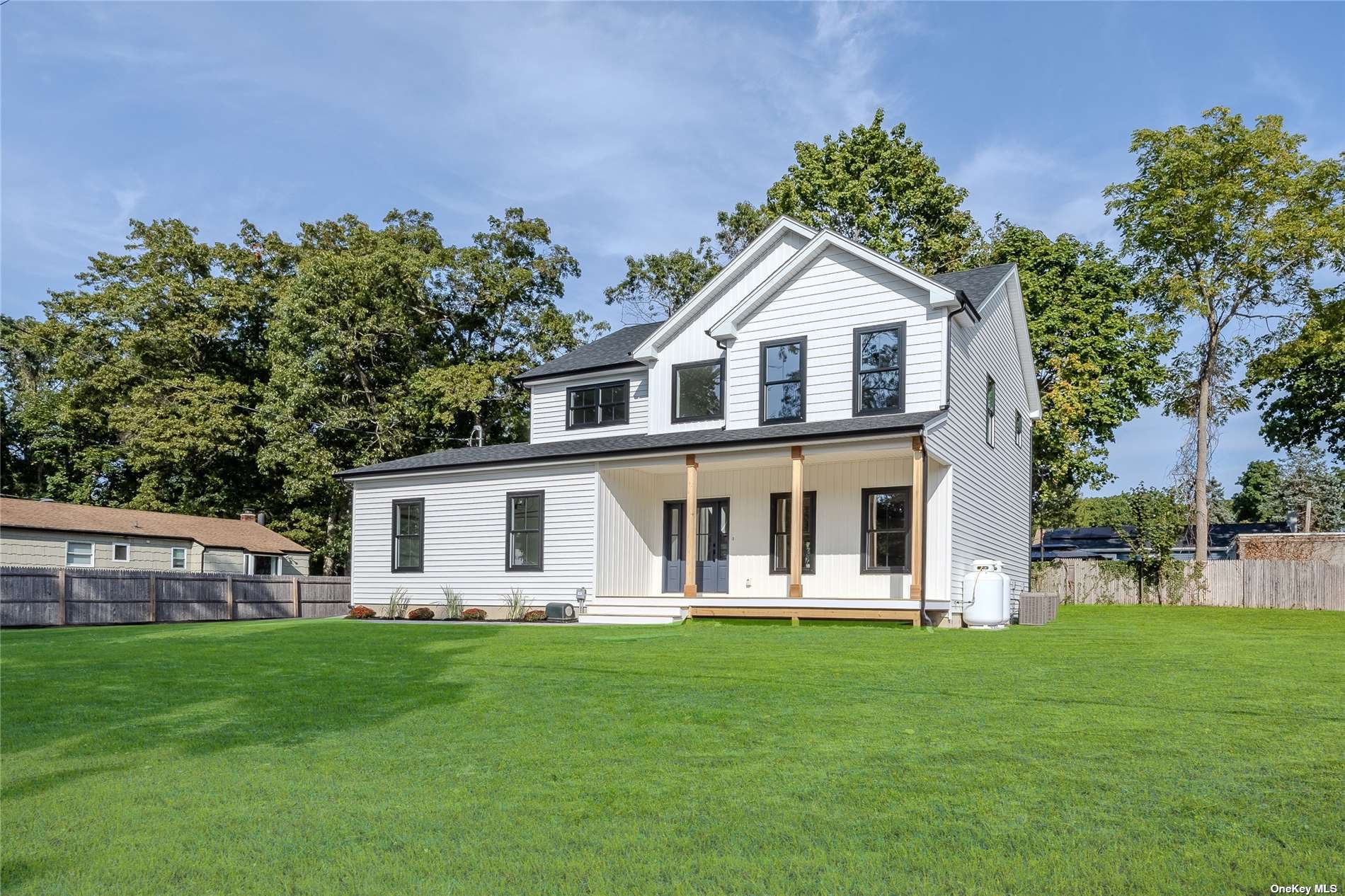 a front view of a house with a garden and porch