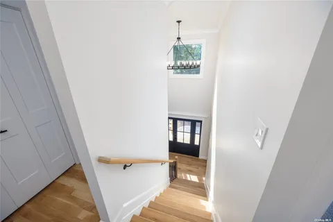 a view of a hallway with wooden floor and entryway