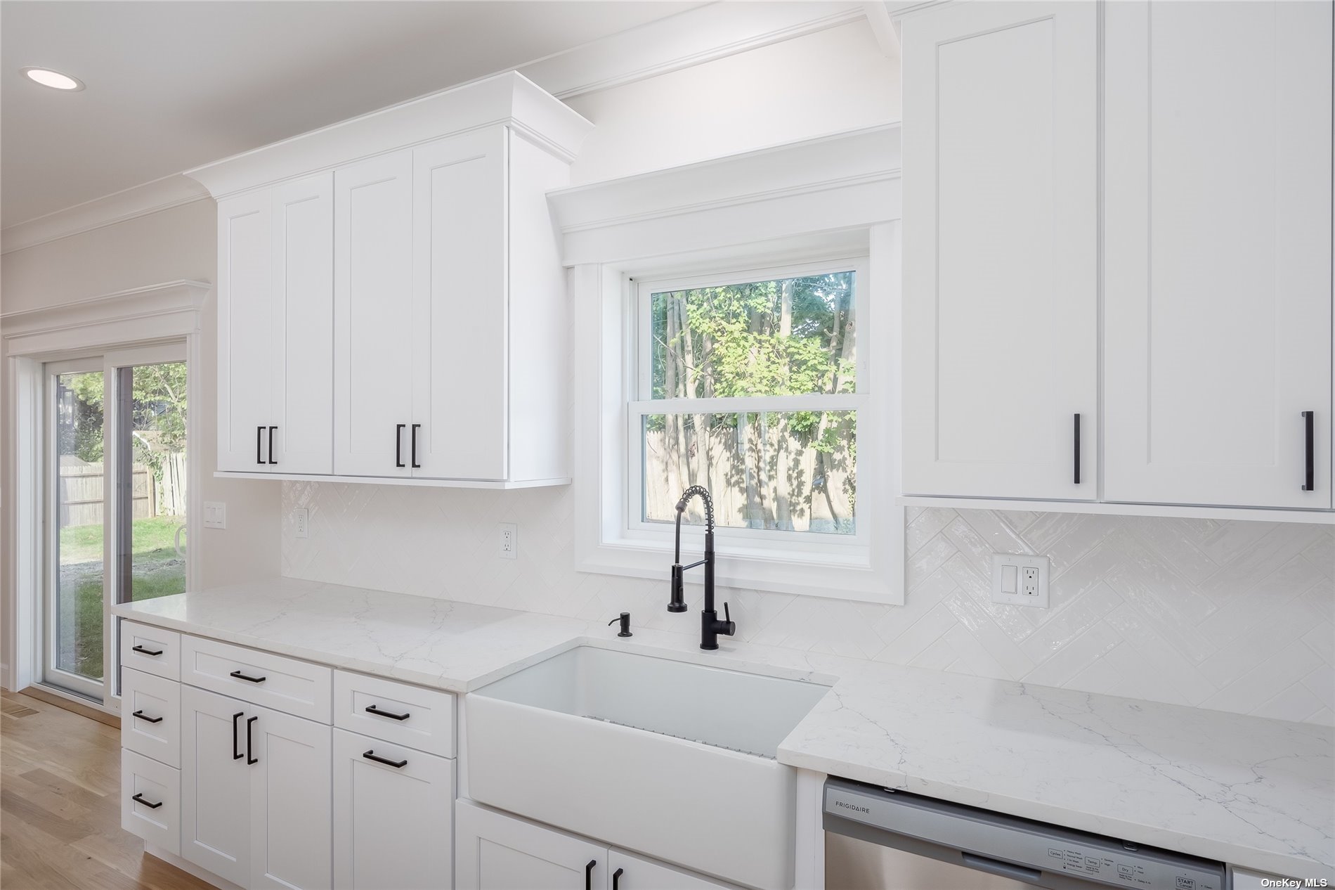 New Constr Pleasant Avenue Centereach, NY 11720 - Photo 7 of 23 a kitchen with white cabinets and a window