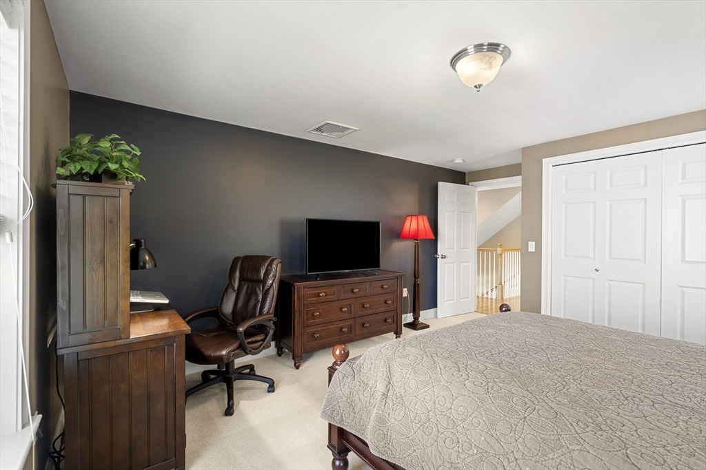 62 Leggs Hill Road Marblehead, MA 01945 - Photo 20 of 36 a bedroom with a bed and a flat screen tv
