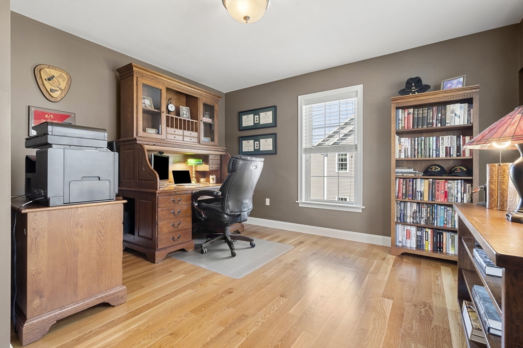 62 Leggs Hill Road Marblehead, MA 01945 - Photo 3 of 36 a view of a workspace with furniture and a bookshelf
