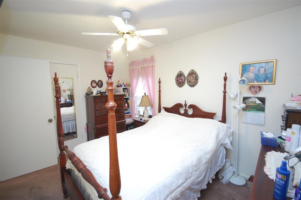 3029 Sienna Road Bartlett, TN 38134 - Photo 13 of 20 a bed room with a bed mirror and a chandelier
