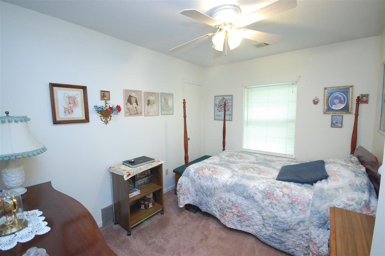 3029 Sienna Road Bartlett, TN 38134 - Photo 14 of 20 a bedroom with a bed and a chandelier