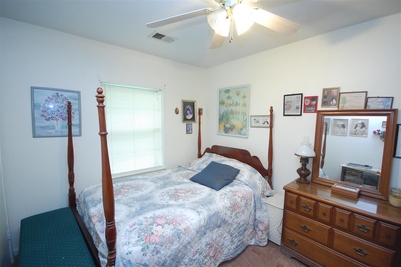 3029 Sienna Road Bartlett, TN 38134 - Photo 15 of 20 a bedroom with a bed and a flat tv screen on the dresser