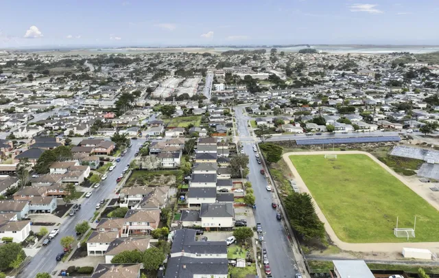 an aerial view of residential houses with outdoor space