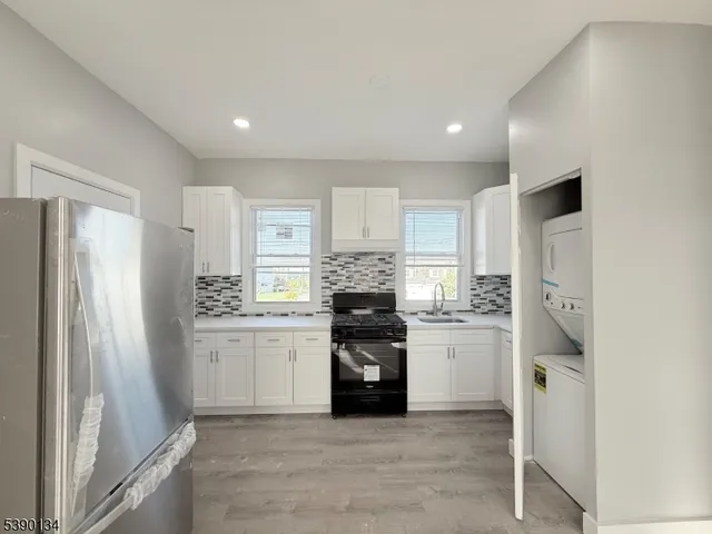 a kitchen with a refrigerator and a stove top oven