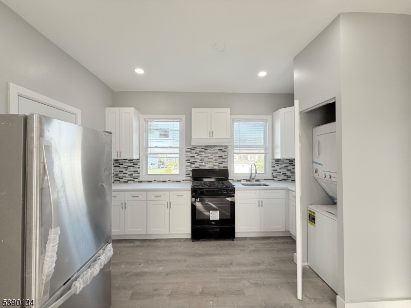 a kitchen with a refrigerator and a stove top oven