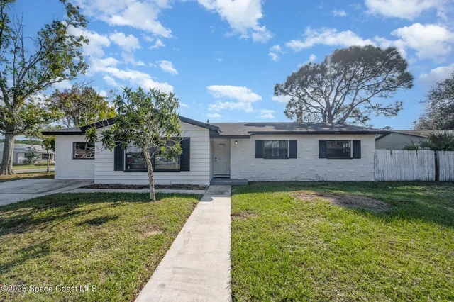 a front view of a house with a yard and porch
