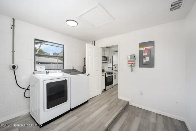 a view with cabinets and wooden floor