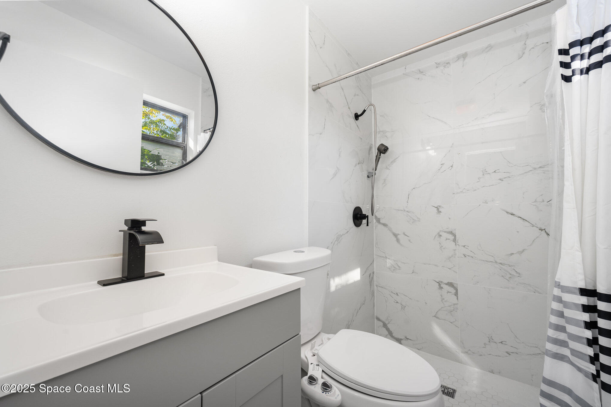 1121 Coronado Drive Rockledge, FL 32955 - Photo 14 of 25 a bathroom with a toilet sink and a mirror