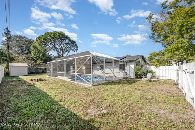 a view of a house with yard and sitting area