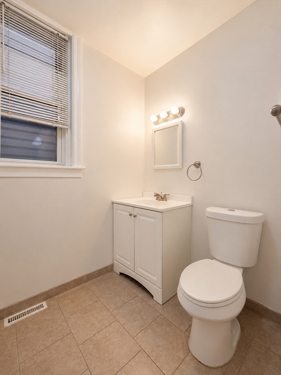128 Shawmut Street, Unit 2 Chelsea, MA 02150 - Photo 11 of 12 a white toilet sitting next to a bathroom sink