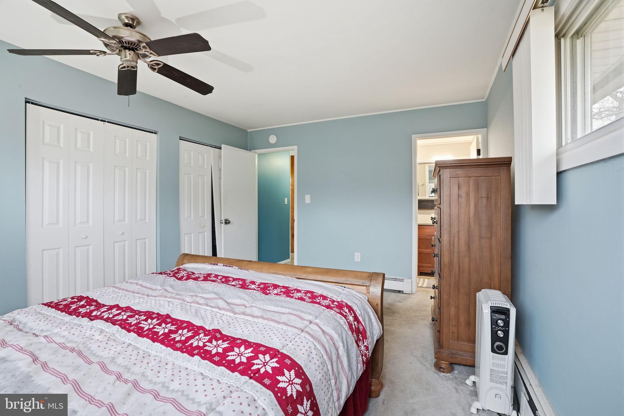 80 Silverspruce Road Levittown, PA 19056 - Photo 16 of 31 a bedroom with a bed and a chandelier