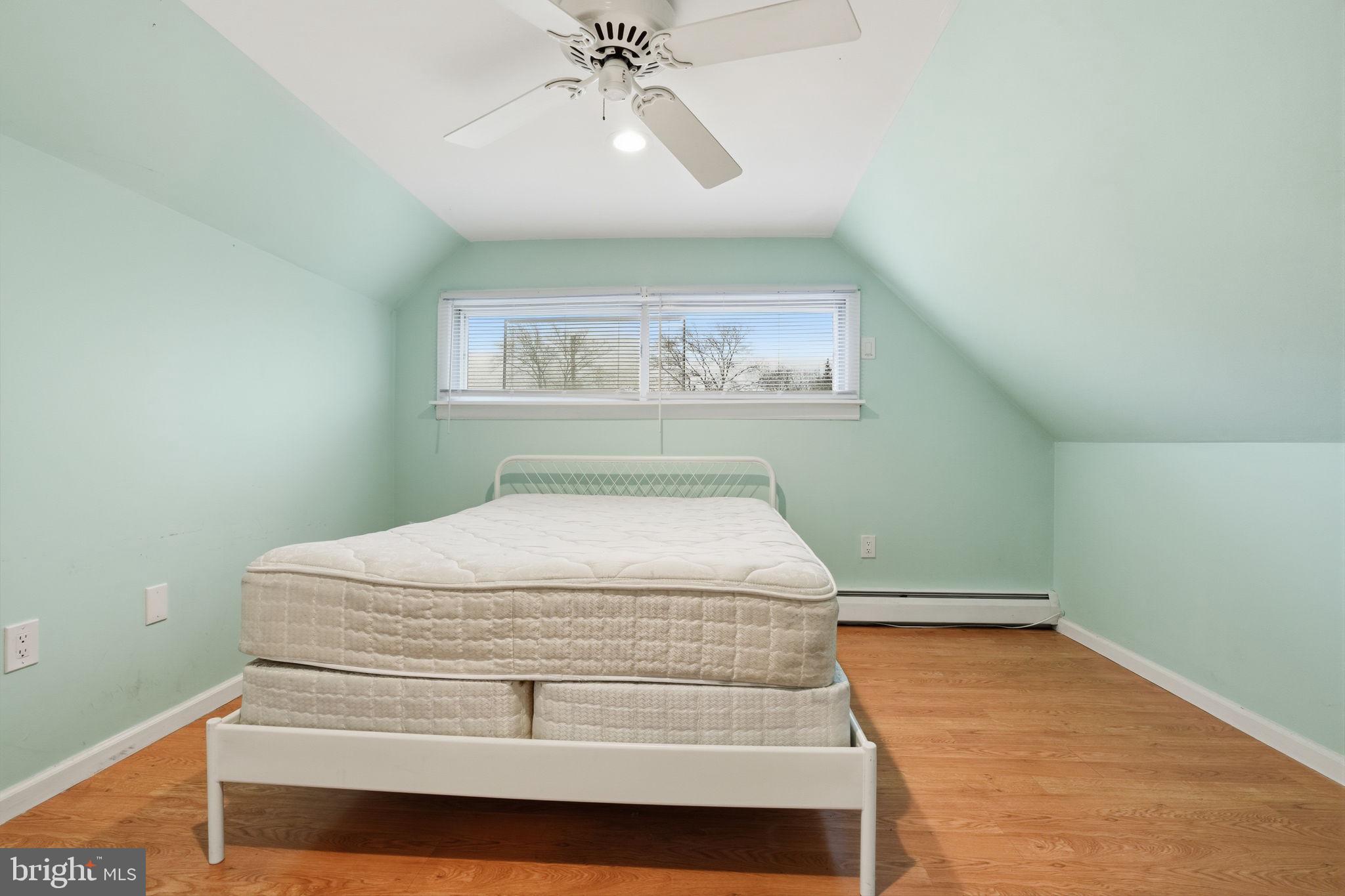 80 Silverspruce Road Levittown, PA 19056 - Photo 21 of 31 a bedroom with a bed and a chandelier