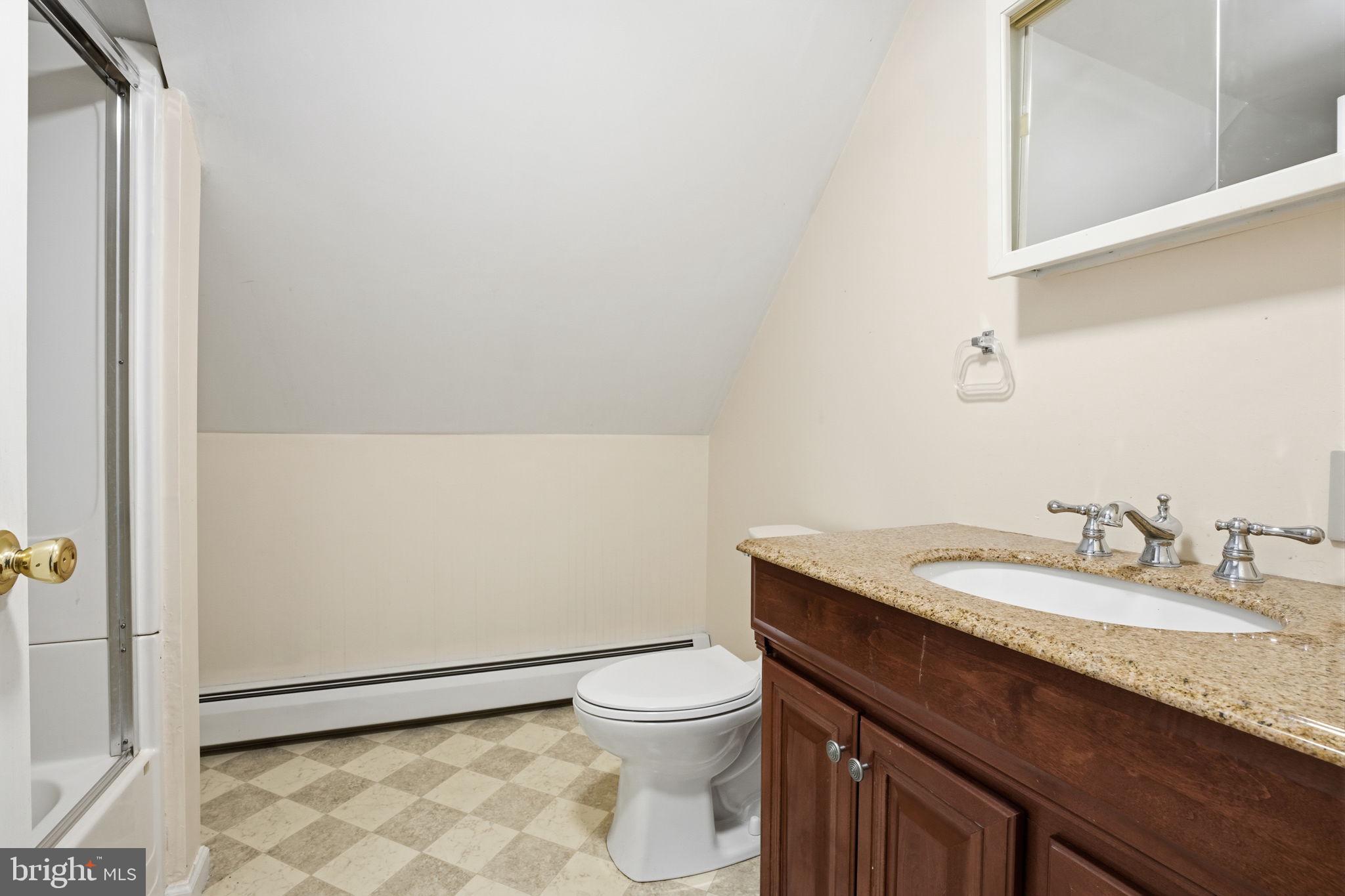 80 Silverspruce Road Levittown, PA 19056 - Photo 23 of 31 a bathroom with a granite countertop toilet a sink and a mirror