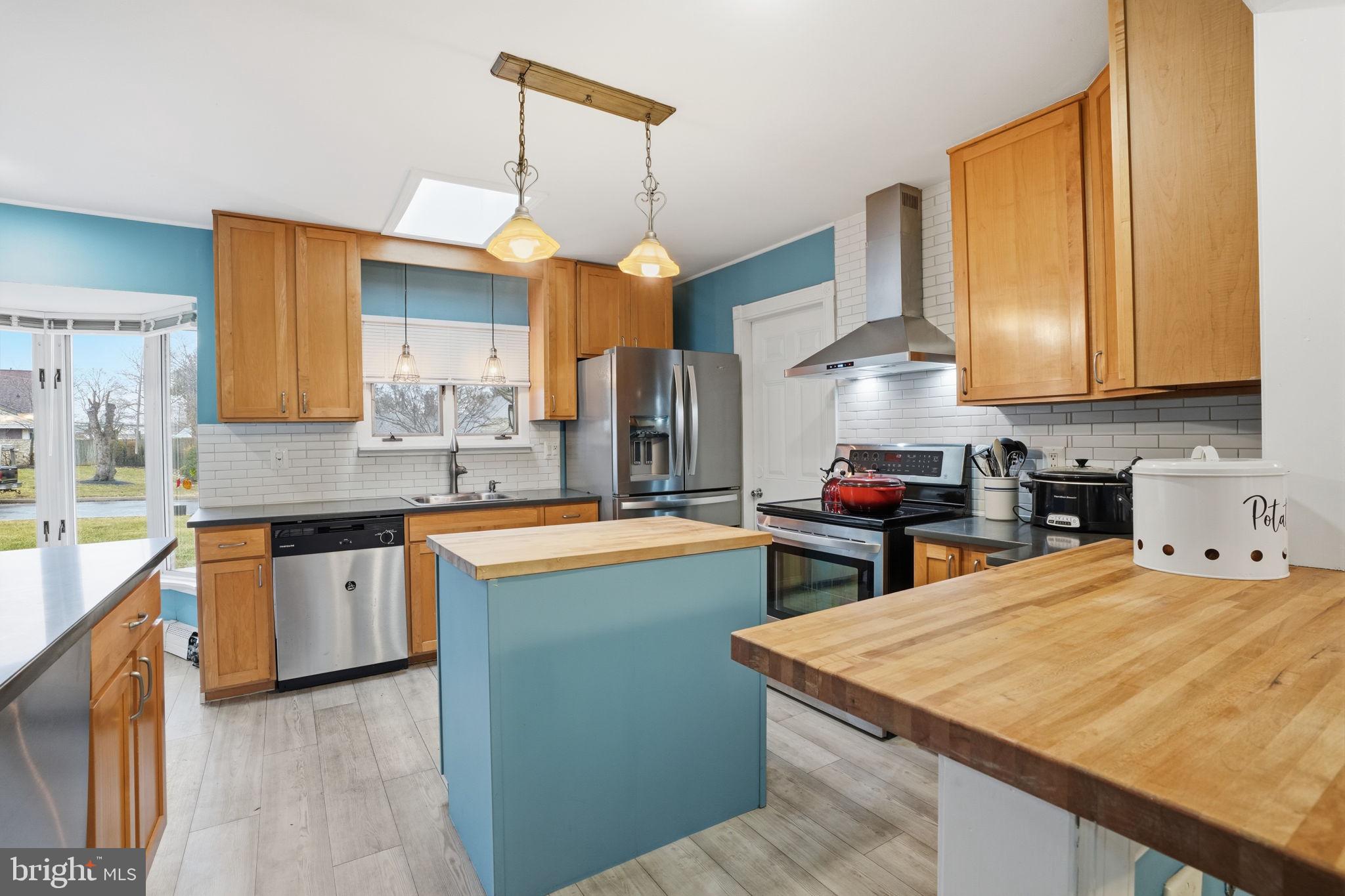 80 Silverspruce Road Levittown, PA 19056 - Photo 10 of 31 a kitchen with a stove a sink a center island and cabinets