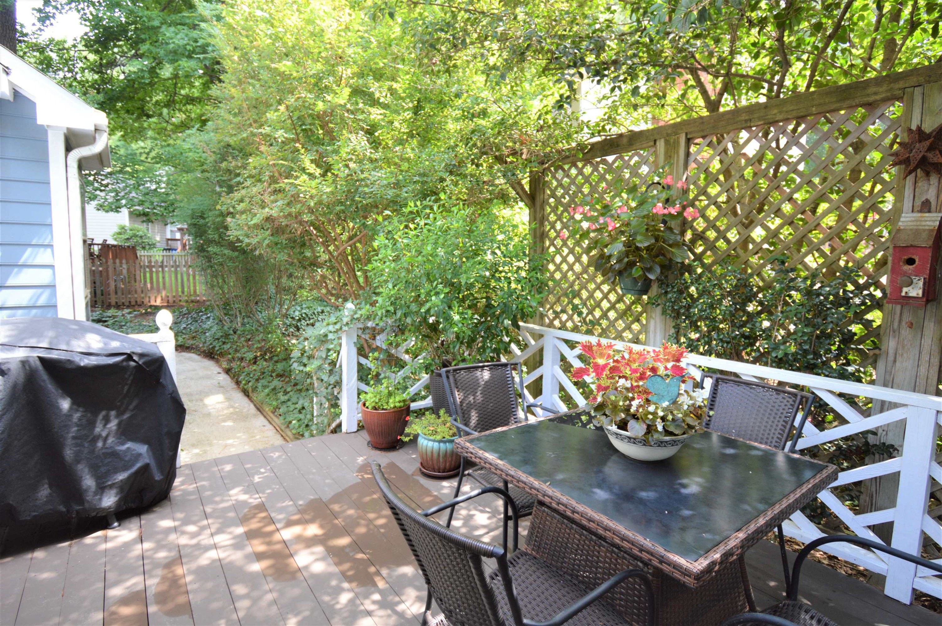 7008 Sandringham Drive Raleigh, NC 27613 - Photo 27 of 52 There is a walkway from the deck to the side yard. Deck